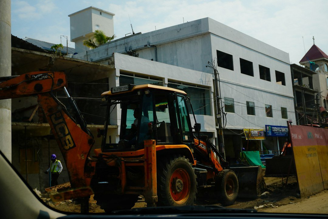 Backhoe loader parked at a construction site, the kind of machine that relies on JCB hydraulic hose assemblies for boom, dipper and loader circuits