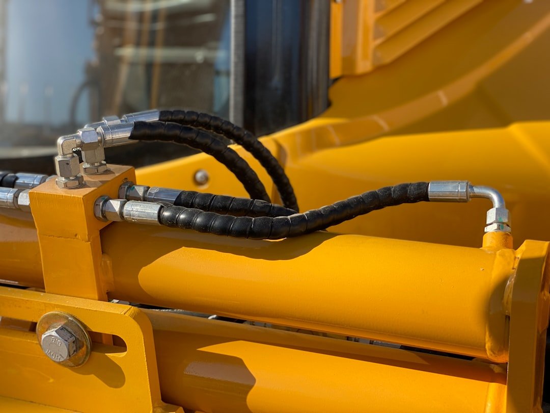 Close up of hydraulic machinery whose hoses must be checked for biodegradable hydraulic fluid hose compatibility