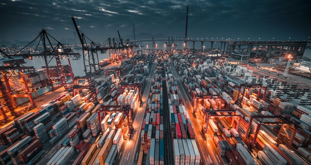 Shipping containers and cranes at a busy port, the route rubber hose export from India takes to Middle East and Africa markets