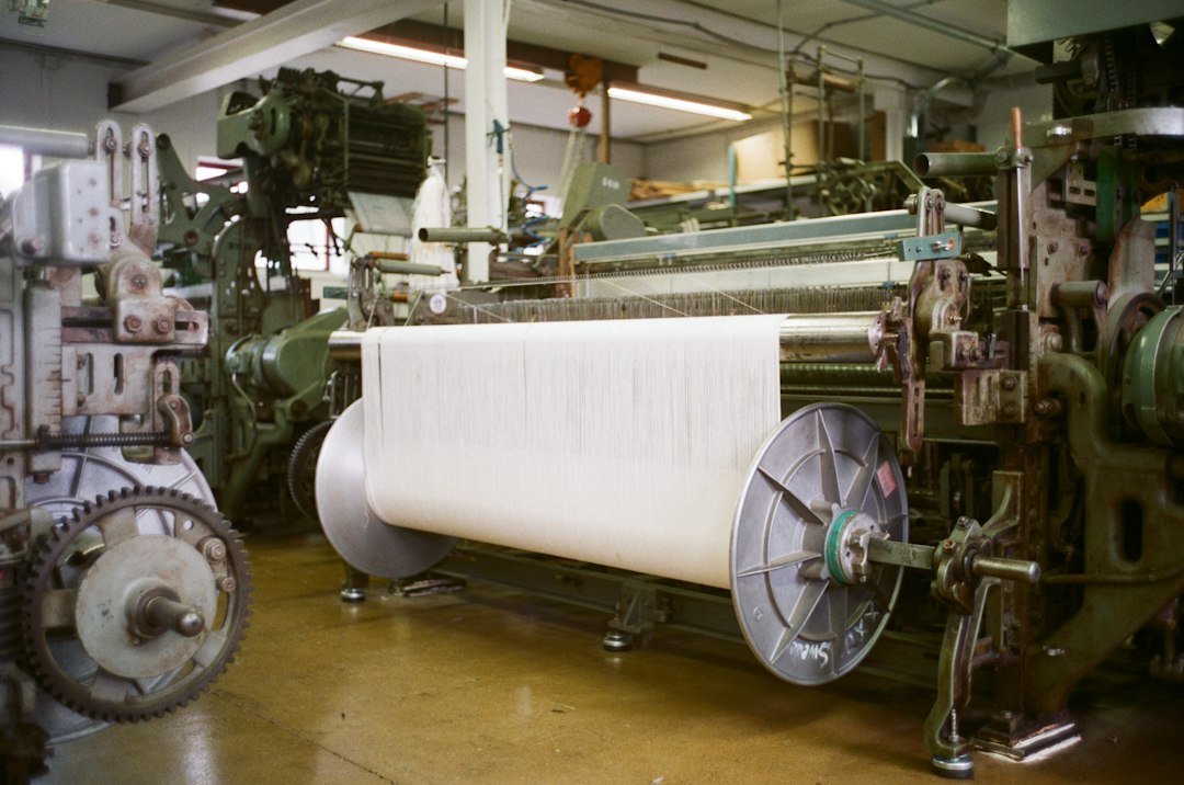 Textile dyeing hoses supply chemicals and steam to machinery in an industrial textile processing factory
